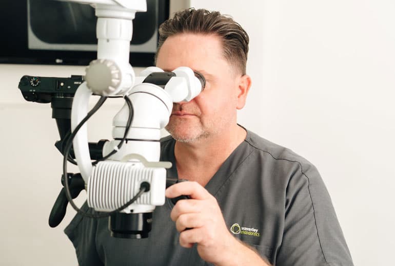 Specialist using dental operating microscope